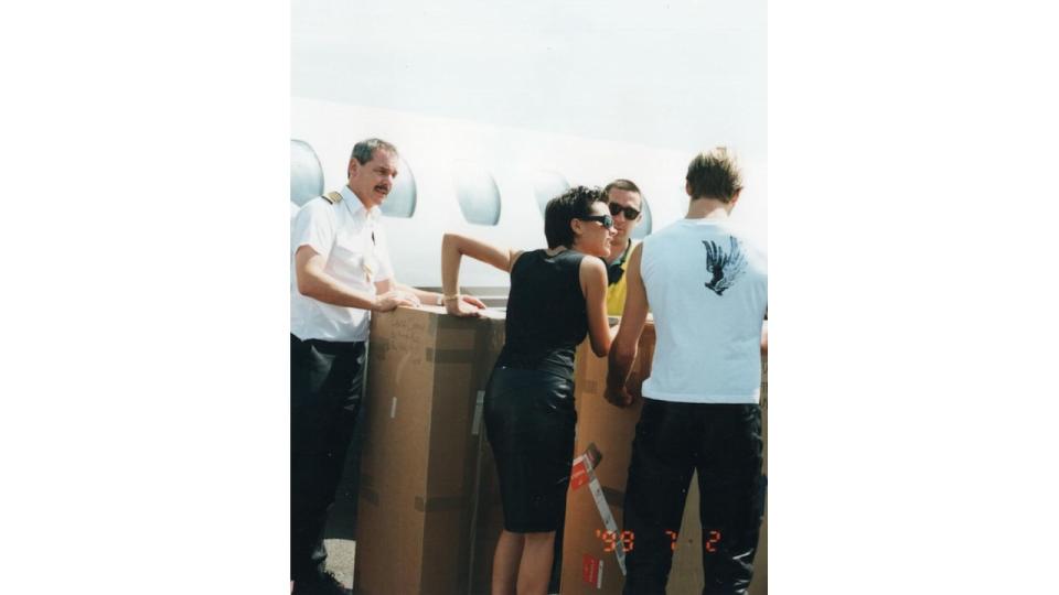 beckhams and aiport staff loading box onto plane