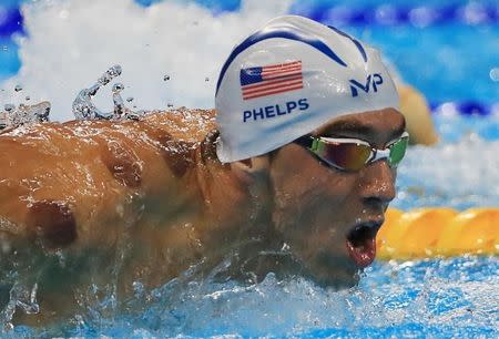 Michael Phelps (USA) of USA is seen with red cupping marks on his shoulder as he competes. REUTERS/Dominic Ebenbichler