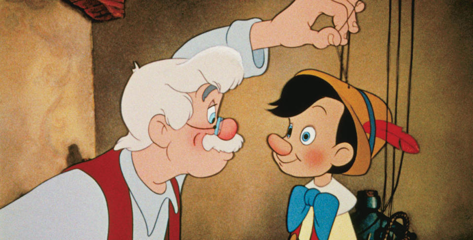 Geppetto holds Pinocchio's strings