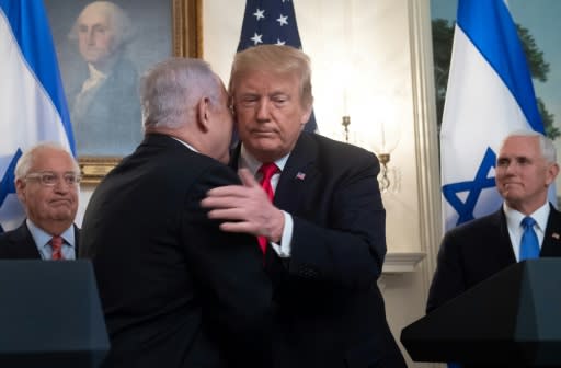 US President Donald Trump and Israeli Prime Minister Benjamin Netanyahu embrace before Trump signs a declaration recognizing Israeli sovereignty over the Golan Heights