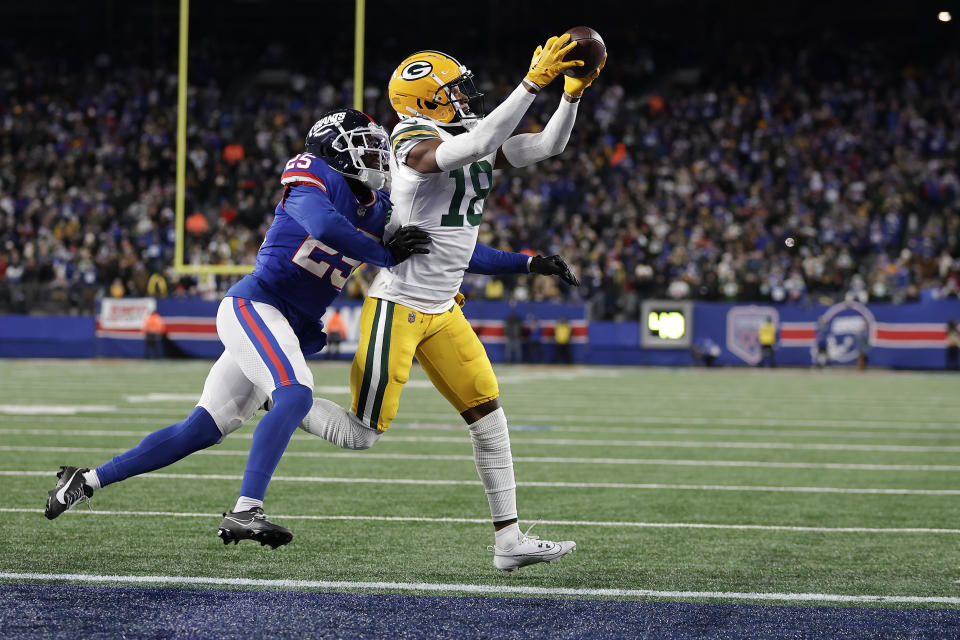 Green Bay Packers wide receiver Malik Heath (18) catches a pass against New York Giants cornerback Deonte Banks (25) for a touchdown during the fourth quarter of an NFL football game, Monday, Dec. 11, 2023, in East Rutherford, N.J. (AP Photo/Adam Hunger)