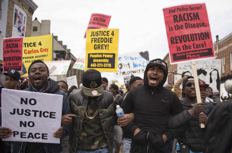 Demonstrators march through the streets protesting the death Freddie Gray, an African American man who died of spinal cord injuries in police custody, in Baltimore, Maryland, April 25, 2015