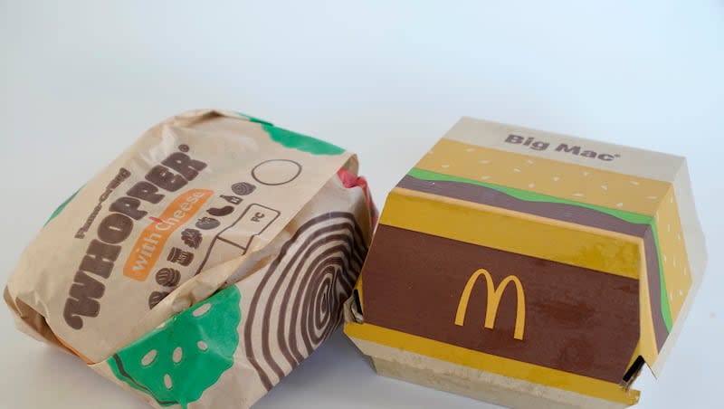 A Burger King Whopper in a wrapper, left, rests next to a McDonald's Big Mac in a container, in Walpole, Mass., Wednesday, April 20, 2022. Food wrappers and packaging that contain “forever chemicals” that can harm human health are no longer being sold in the U.S., the Food and Drug Administration announced Wednesday, Feb. 28, 2024.