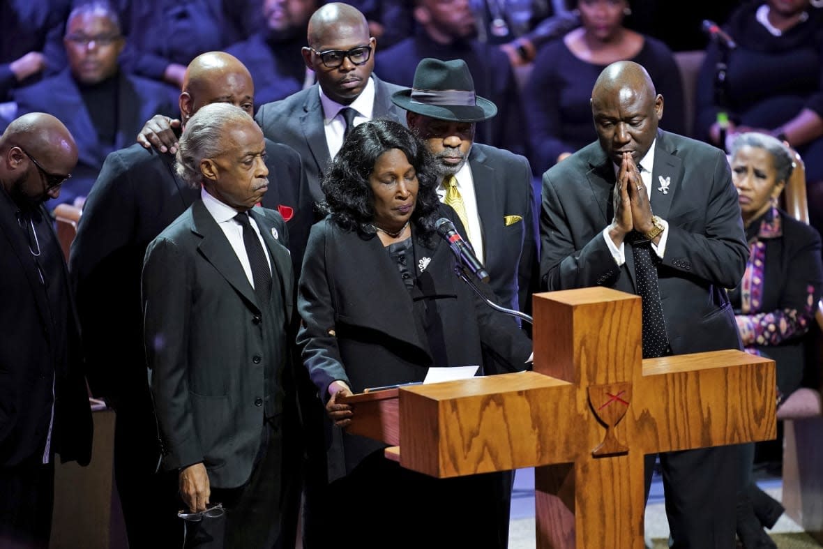 Flanked by Rev. Al Sharpton, left, her husband Rodney Wells, second from right, and attorney Benjamin Crump, right, RowVaughn Wells speaks during the funeral service for her son Tyre Nichols at Mississippi Boulevard Christian Church in Memphis, Tenn., on Wednesday, Feb. 1, 2023. (Andrew Nelles/The Tennessean via AP, Pool)