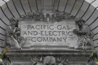 FILE - In this April 16, 2020, file photo, a Pacific Gas & Electric sign is seen on the exterior of a PG&E building in San Francisco. The nation's largest utility limped into bankruptcy vilified for its long-running neglect of a crumbling electrical grid that ignited horrific Northern California wildfires that left entire cities in ruins. After nearly a year-and-a-half of wrangling during one of the most complex bankruptcy cases in U.S. history, it’s unclear if PG&E is now any better equipped to protect the 16 million people who rely on it for power. (AP Photo/Jeff Chiu, File)