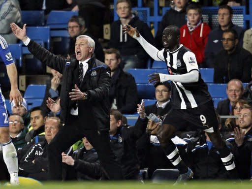 Newcastle United manager Alan Pardew (L) and Papiss Cisse during the match against Chelsea on May 2. hailed Cisse after taking his tally since his January move from German club Freiburg to 13 goals in 12 games