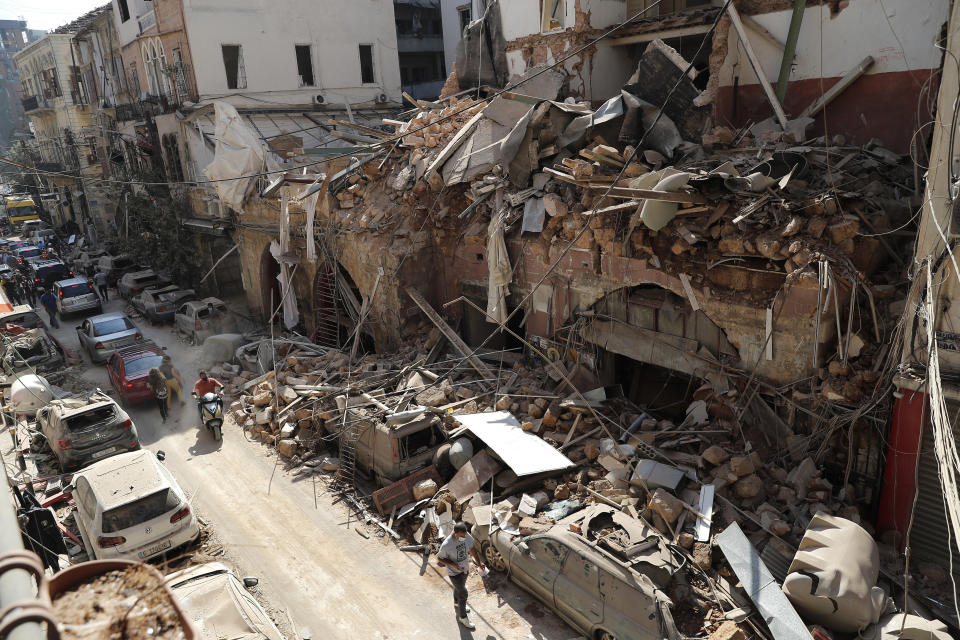 FILE - Cars line one of the damaged roads a day after a massive explosion hit the seaport of Beirut, Lebanon, Aug. 5, 2020. It has been two years since a warehouse full of ammonium nitrate at Beirut's port exploded, destroying large parts of the city, killing more than 215 people and injuring thousands. In 2022 many families are losing hope of ever finding justice. (AP Photo/Hussein Malla, File)