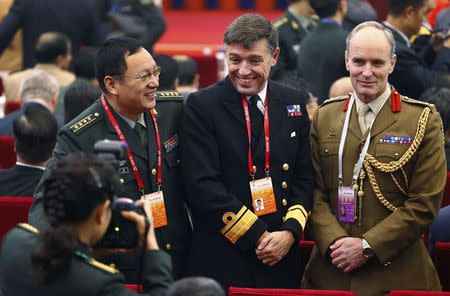 (L-R) Chinese military academic delegate Wang Yisheng talks to British delegate John Kingwell and Observer Simon Levey during a security forum attended by senior officials and academics from Central Asia and the Asia-Pacific, in Beijing, November 21, 2014. REUTERS/Petar Kujundzic