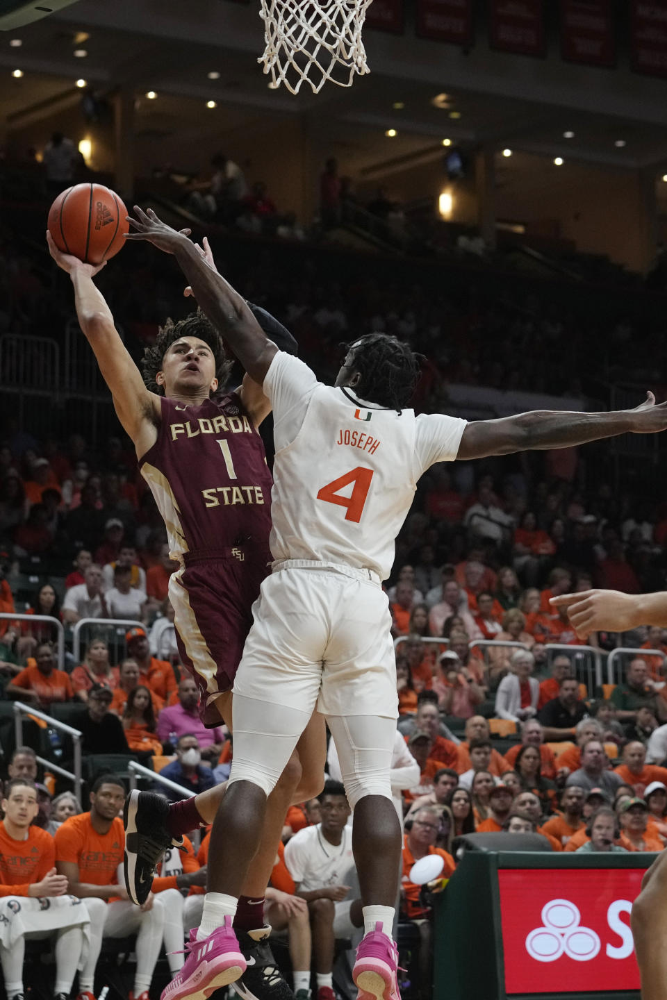 Florida State guard Jalen Warley (1) aims to score as Miami guard Bensley Joseph (4) defends during the first half of an NCAA college basketball game, Saturday, Feb. 25, 2023, in Coral Gables, Fla. (AP Photo/Marta Lavandier)