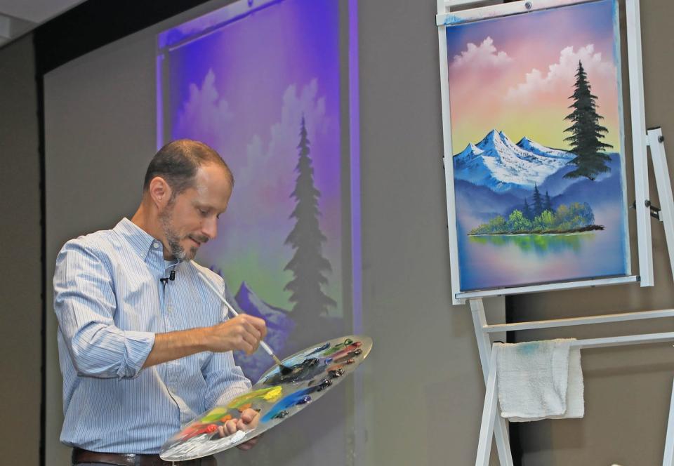 Nicholas Hankins chats about his life and paints live in front of an audience during the The Joy Continues event at the Brannon Center in New Smyrna Beach, Thursday, April 4, 2024.