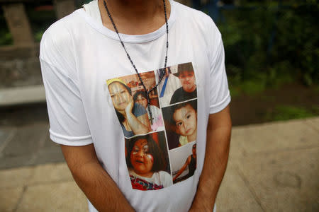 Alejandro Ochoa poses for a photograph while wearing a shirt with the pictures of his children who live in the U.S., during a protest outside the U.S Embassy in Mexico City, Mexico September 5, 2017. REUTERS/Alejandro Cegarra
