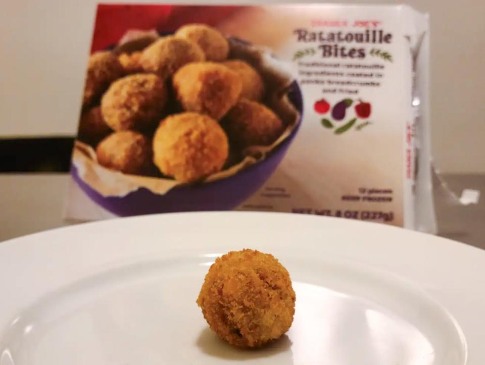Trader Joe's ratatouille bite on a plate with a white box of bites behind the plate