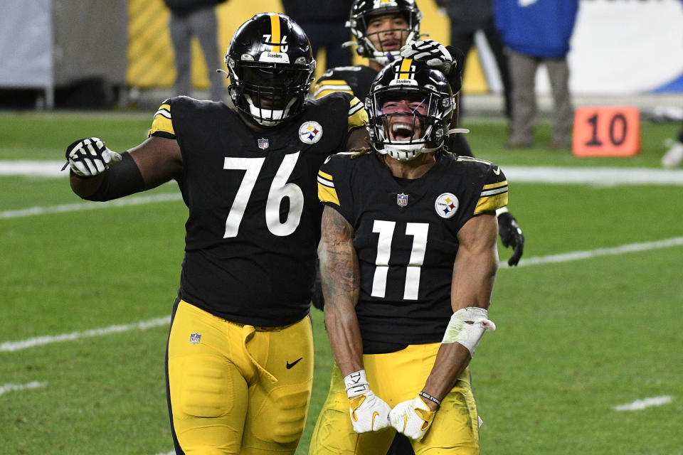 Pittsburgh Steelers wide receiver Chase Claypool (11) celebrates with Chukwuma Okorafor (76) his scoring on a 5-yard touchdown pass from quarterback Ben Roethlisberger during the second half of an NFL football game against the Cincinnati Bengals in Pittsburgh, Sunday, Nov. 15, 2020. (AP Photo/Don Wright)