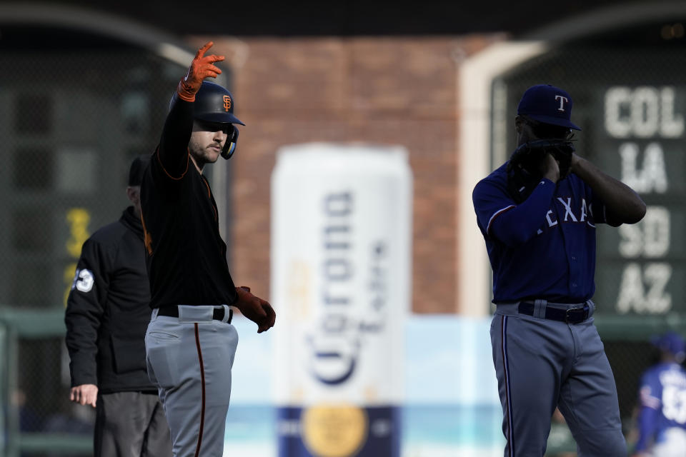 San Francisco Giants' Patrick Bailey, left, reacts after hitting an RBI single against the Texas Rangers during the first inning of a baseball game Saturday, Aug. 12, 2023, in San Francisco. (AP Photo/Godofredo A. Vásquez)