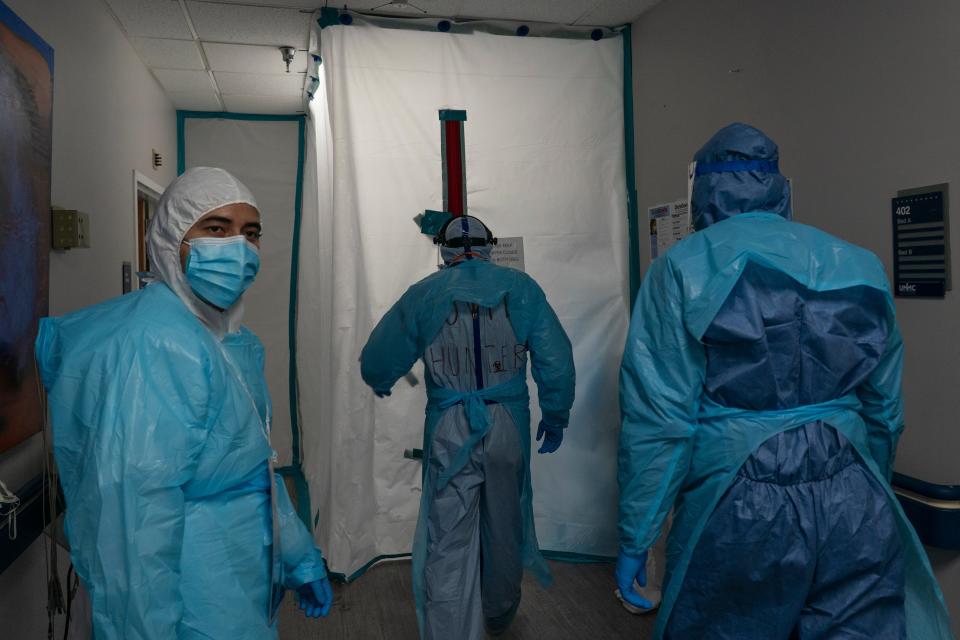 Medical staffers wearing coveralls and face masks enter the Covid-19 intensive care unit (ICU) at the United Memorial Medical Centre on 29 November 2020 in Houston, Texas ((Getty Images))