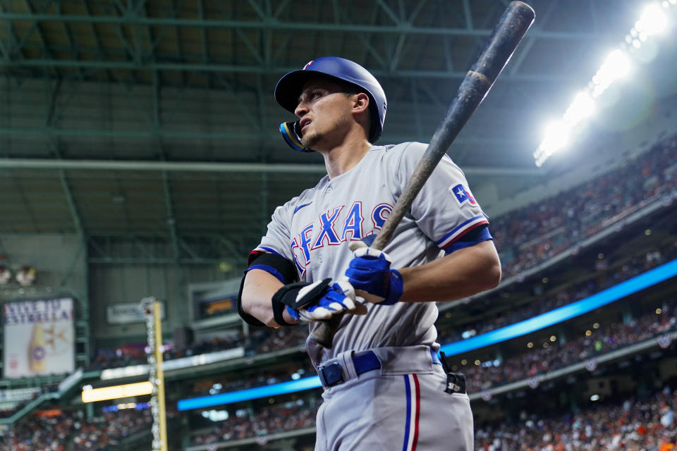 FILE - Texas Rangers' Corey Seager warms up before Game 2 of the baseball team's American League Championship Series against the Houston Astros, Oct. 16, 2023, in Houston. The Rangers get another opportunity to celebrate the franchise's first World Series championship before they begin their title defense against Cody Bellinger and the Chicago Cubs on opening day. Seager is back for Texas after playing a starring role in October, (AP Photo/Godofredo A. Vásquez, File)