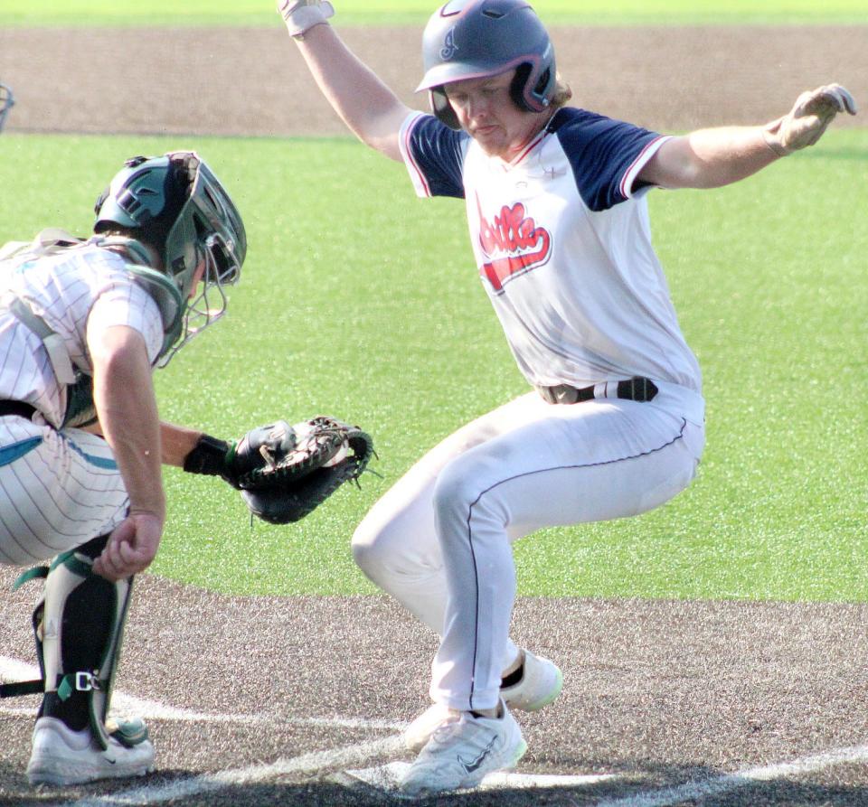 Doenges Ford Indians baserunner Kaeden Young, right, completes a steal of home plate during baseball tourney action on July 19, 2023, at Bill Doenges Memorial Stadium. The Indians beat the Drillers (Cushing), 8-2.