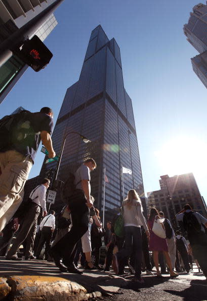 Commuters walk past the former Sears Tower July 16, 2009 in Chicago, Illinois. The building was renamed the Willis Tower today, after London-based insurance broker Willis Group Holdings, a major tenant in the building. The building, once the tallest in the world, was opened in 1973 to house the offices of the then largest retailer in the world Sears, Roebuck & Co. (Photo by Scott Olson/Getty Images)