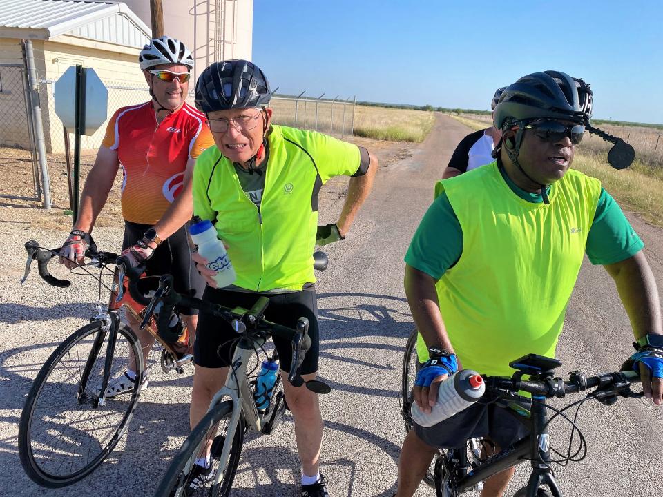 Bo Green, center, and his group of bicycle riders pause to determine whether to stay on their planned route or alter it so Green could get in his 80 miles. They stayed the course and Green, who is 80, completed his fundraiser for Meals on Wheels. June 25 2022