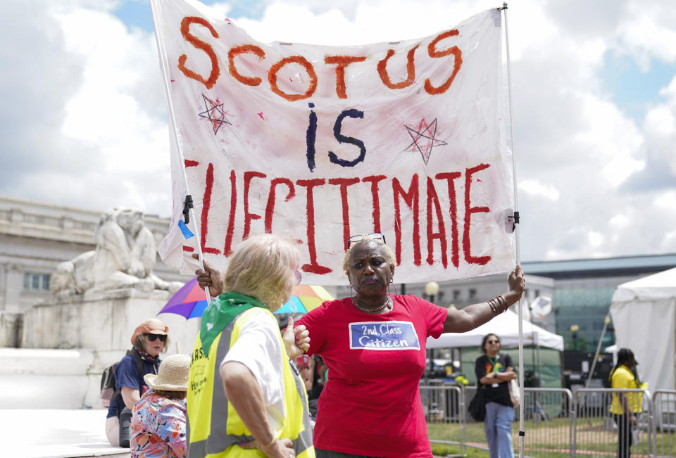 A demonstrator holds a sign as people gather for the Women's March in Washington, Saturday, June 24, 2023. (AP Photo/Stephanie Scarbrough)