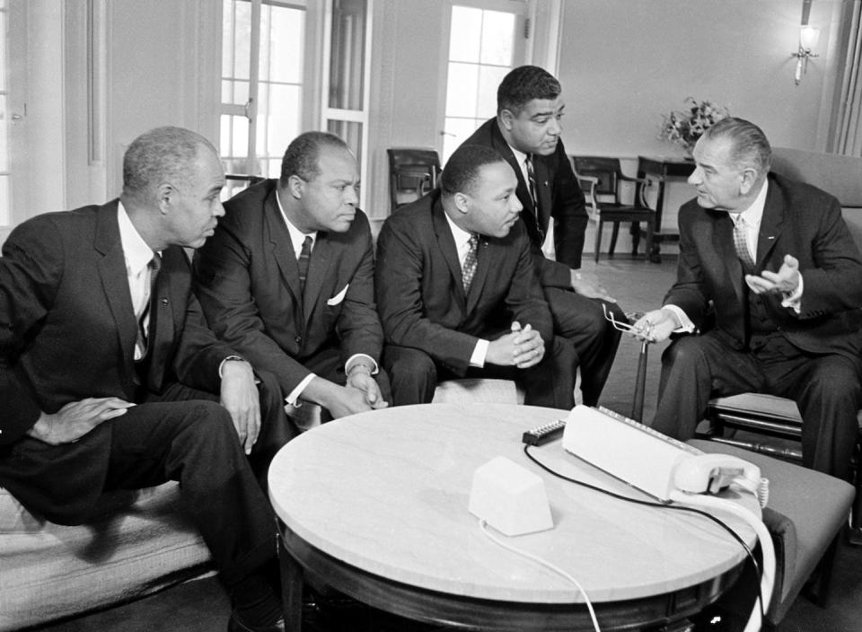 U.S. President Lyndon B. Johnson, right, talks with civil rights leaders at the White House in Washington, Jan. 18, 1964. AP Photo