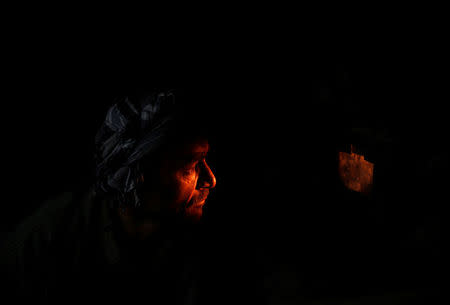 A worker looks at an oven through a small hole at the Jabal Saraj cement factory in Jabal Saraj, north of Kabul, Afghanistan April 19, 2016. REUTERS/Ahmad Masood