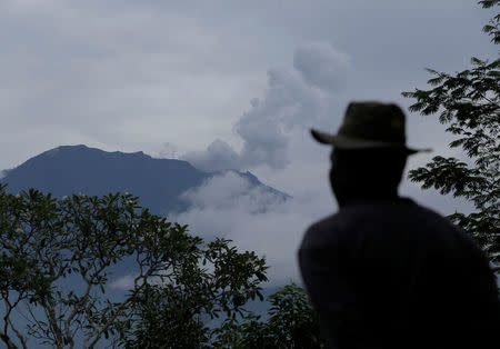 A villager looks at Mount Agung following a phreatic eruption in Rendang Village, Karangasem, Bali, Indonesia November 22, 2017. REUTERS/Johannes P. Christo