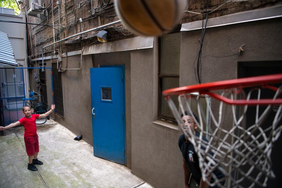 Landon Rodriguez plays basketball with mentor Rakim Isaacs from his tutoring program at Friends of the Children.