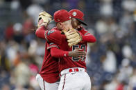 Arizona Diamondbacks shortstop Geraldo Perdomo, left, celebrates a victory with Christian Walker, right, after the final out in the second baseball game of a doubleheader against the San Diego Padres, Saturday, Aug 19, 2023, in San Diego. (AP Photo/Brandon Sloter)
