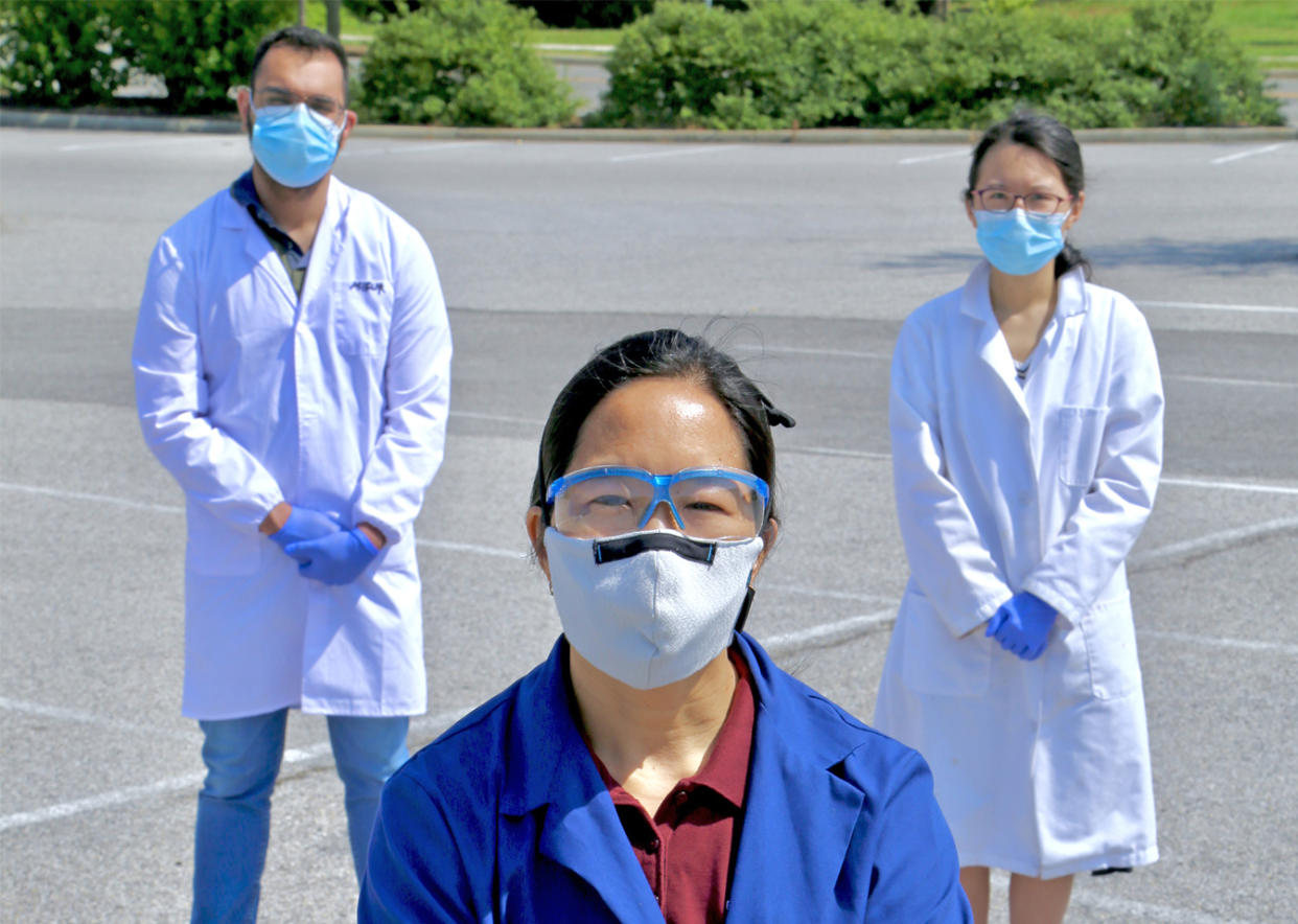 Linsey Marr, the Charles P. Lunsford professor of Civil and Environmental Engineering at Virginia Tech and an expert in airborne disease transmission, stands with Ph.D. students Charbel Harb and Jin Pan. (Alex Crookshanks/Virginia Tech)