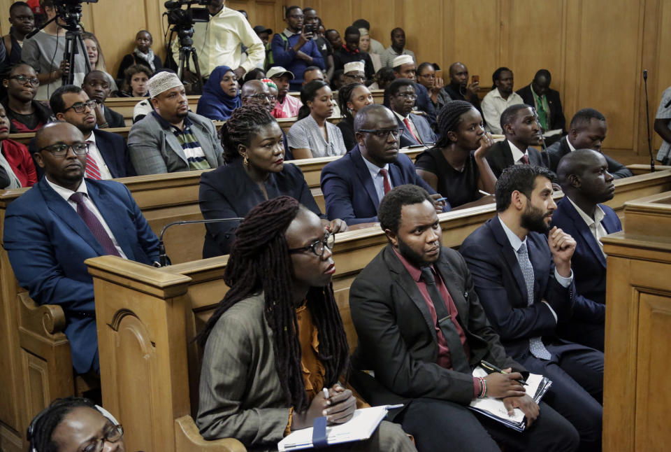 Environmental activists and petitioners listen to a tribunal ruling over the construction of a coal-fired power plant, at the supreme court building in Nairobi, Kenya Wednesday, June 26, 2019. The Kenyan tribunal blocked the construction of the government-backed plant in Lamu County, which hosts a UNESCO world heritage site and which activists said would cause environmental damage. (AP Photo/Khalil Senosi)