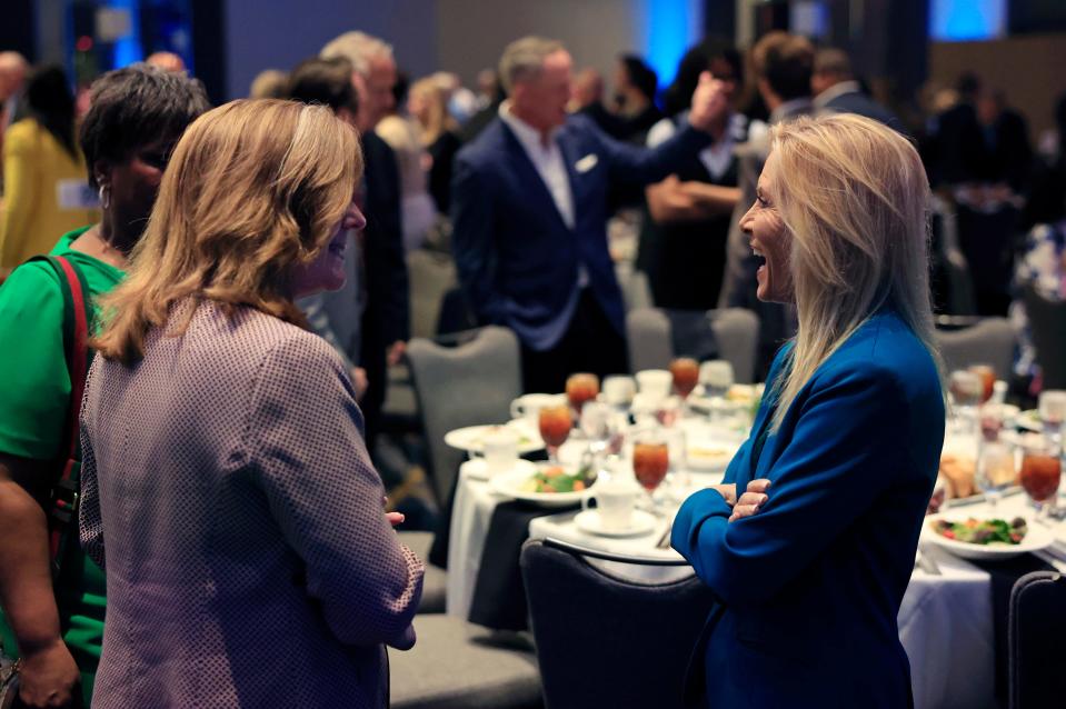 Cindy Funkhouser, CEO of the Sulzbacher Center, left, speaks to Mayor Donna Deegan during a JAXUSA Partnership luncheon March 28 at the Hyatt Regency Jacksonville Riverfront hotel.