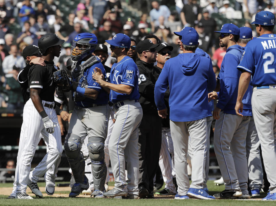 Chicago White Sox's Tim Anderson, left, talks to Kansas City Royals catcher Martin Maldonado after being hit by a pitch during the sixth inning of a baseball game in Chicago, Wednesday, April 17, 2019. (AP Photo/Nam Y. Huh)