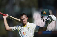 Australia's Marnus Labuschagne raises his bat and helmet as he walks off after he is dismissed by the West Indies on the second day of their cricket test match in Adelaide, Friday, Nov. 9, 2022. (AP Photo/James Elsby)