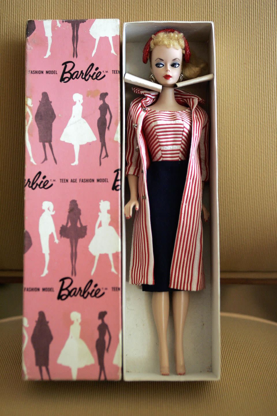 a barbie doll is displayed at the room o