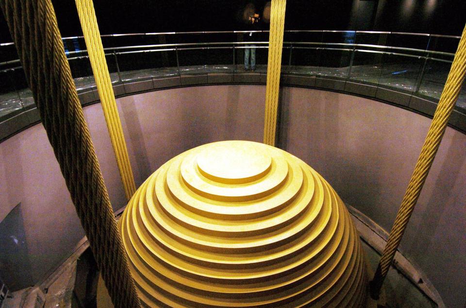 image of massive steel ball hanging from chords