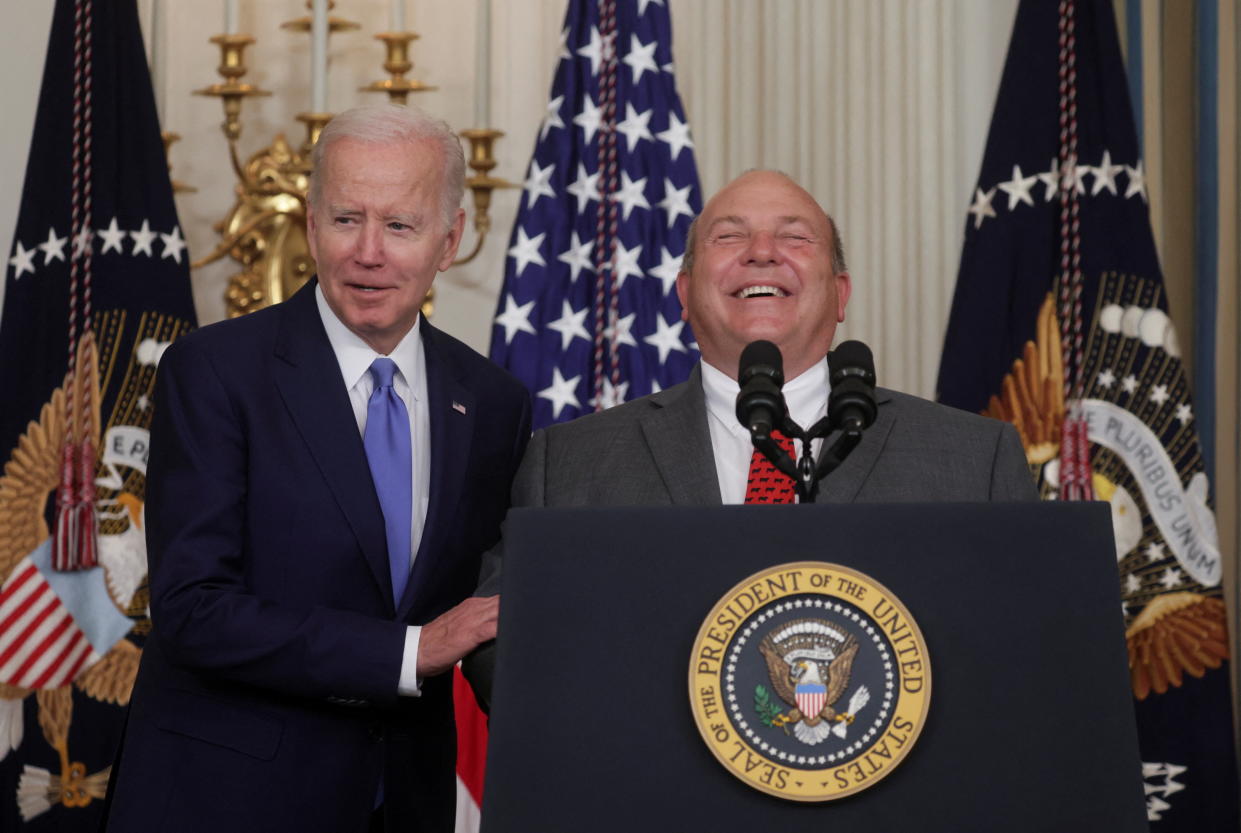 U.S. President Joe Biden speaks as Vincent “Zippy” Duvall, President of the American Farm Bureau Federation laughs, as they attend the signing into law the Ocean Shipping Reform Act of 2022, which will level the playing field for American exporters and importers, including farmers, and reduce costs for American consumers by lowering the cost of ocean shipping, at the White House in Washington, U.S., June 16, 2022. REUTERS/Evelyn Hockstein