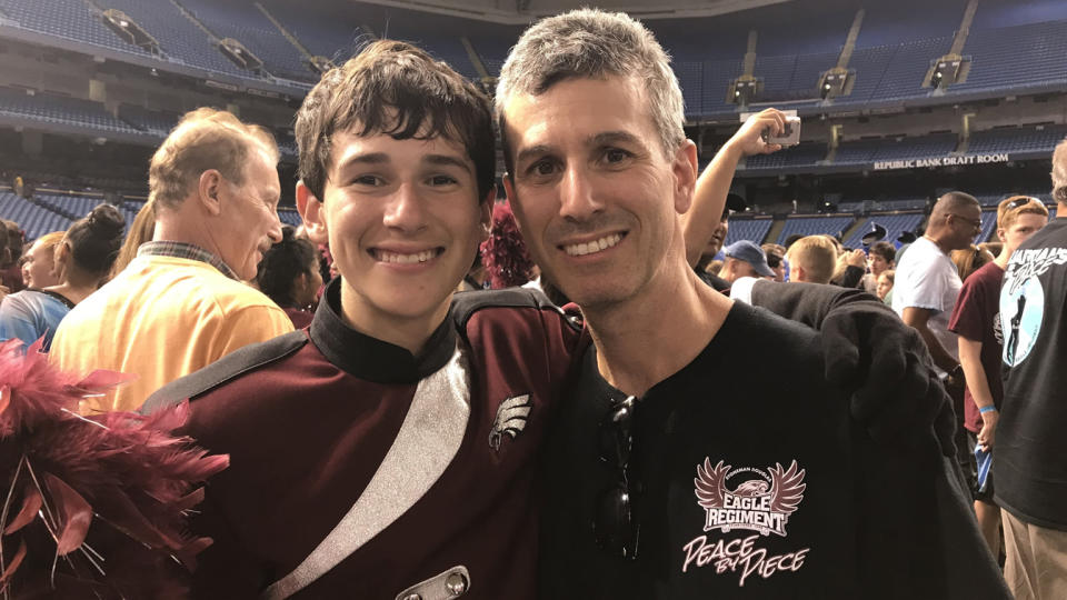 Max Schachter hugs his son Alex Schachter.