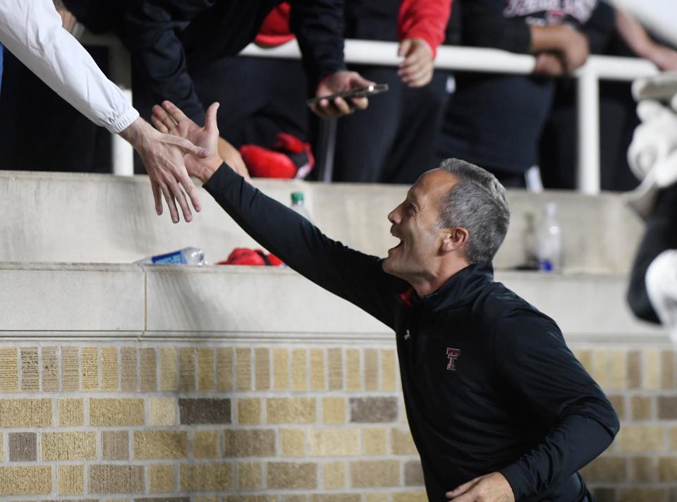 Texas Tech's head basketball coach Grant McCasland high-fives fans during the game against Kansas State, Saturday, Oct. 14, 2023, at Jones AT&T Stadium.