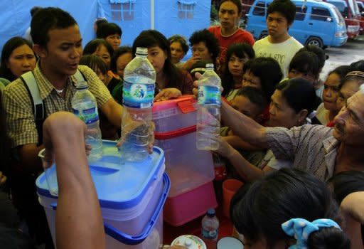 Evacuees are seen here queuing for water in Tomohon, on July 15. A series of eruptions at Indonesian volcano have thrown rocks, lava and ash hundreds of metres into the air and forced thousands of people to flee, according to officials