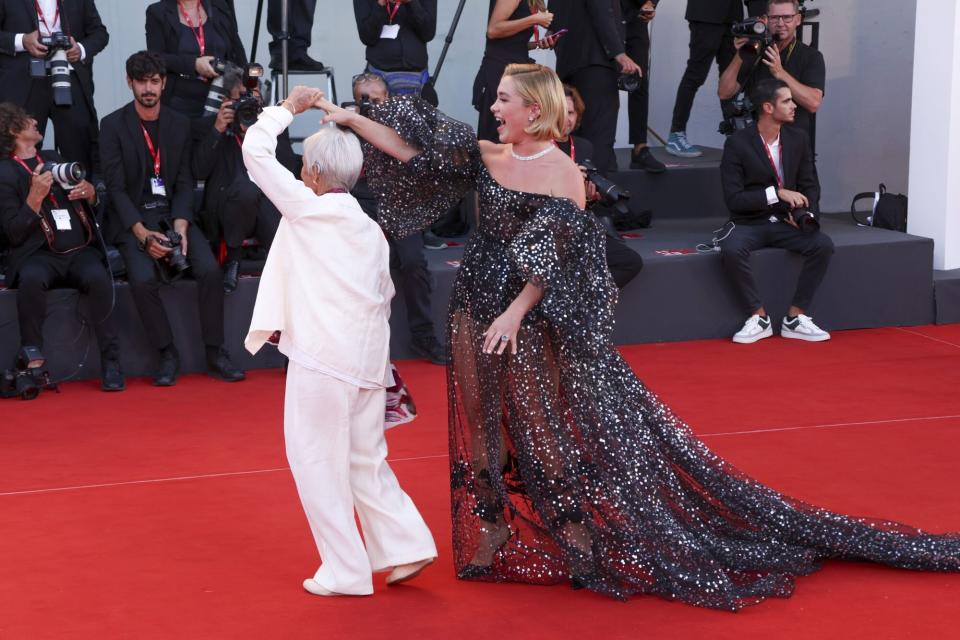Mandatory Credit: Photo by Joel C Ryan/Invision/AP/Shutterstock (13366898ew) Florence Pugh, right, poses for photographers upon arrival at the premiere of the film 'Don't Worry Darling' during the 79th edition of the Venice Film Festival in Venice, Italy Film Festival 2022 Don't Worry Darling Red Carpet, Venice, Italy - 05 Sep 2022