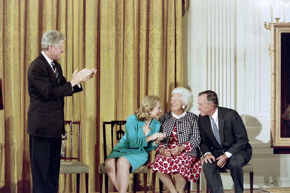 <p>President Bill Clinton and First Lady Hillary Clinton share a light moment with Barbara Bush and former President George H.W. Bush during the unveiling of the Bush formal portraits in the East Room of the White House on July 17, 1995.</p>