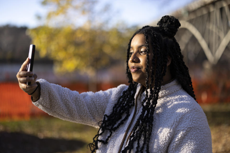 High school student Mecca Patterson-Guridy takes a self portrait in Philadelphia, Friday, Dec. 9, 2022. Scrutiny from conservatives around teaching about race, gender and sexuality has made many teachers reluctant to discuss issues that touch on cultural divides. To fill in gaps, some students, including Mecca, are looking to social media, where online personalities, nonprofit organizations and teachers are experimenting with ways to connect with them outside the confines of school. (AP Photo/Ryan Collerd)