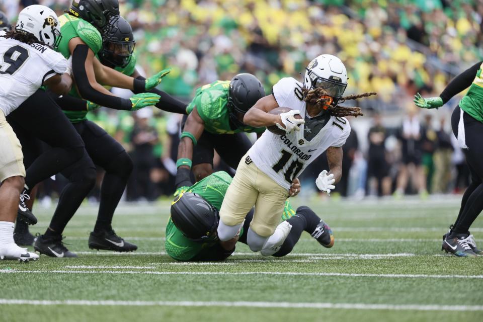 Colorado wide receiver Xavier Weaver (10) is tackled by Oregon defensive tackle Popo Aumavae (50) during the second half at Autzen Stadium.