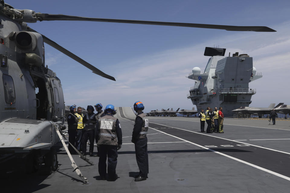 Military personnel on board the aircraft carrier HMS Queen Elizabeth as it participates in the NATO Steadfast Defender 2021 exercise off the coast of Portugal, Thursday, May 27, 2021. NATO has helped provide security in Afghanistan for almost two decades but the government and armed forces in the conflict-torn country are strong enough to stand on their own feet without international troops to back them, the head of the military organization said Thursday. (AP Photo/Ana Brigida)