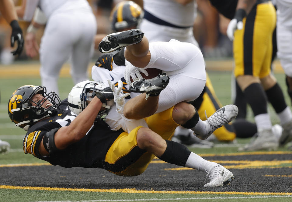 Iowa linebacker Jack Campbell (31) rips down Penn State wide receiver Parker Washington (3) during the first half of an NCAA college football game, Saturday, Oct. 9, 2021, in Iowa City, Iowa. (AP Photo/Matthew Putney)