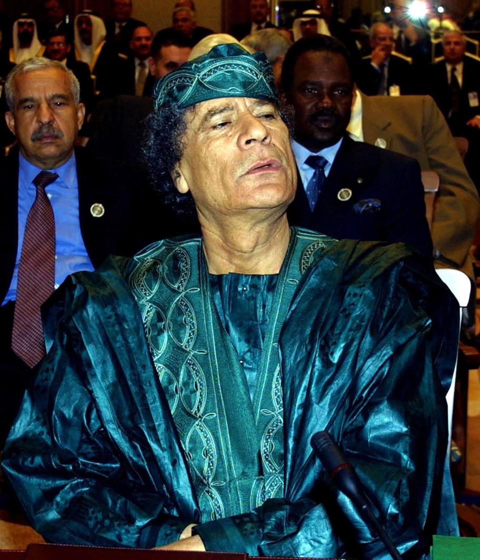 Gaddafi causes a splash in a melange of cool blue and green shades in a silky fabric that was surely the envy of the other delegates.     Gaddafi attends the opening session of the Arab summit in Amman in 2001. 