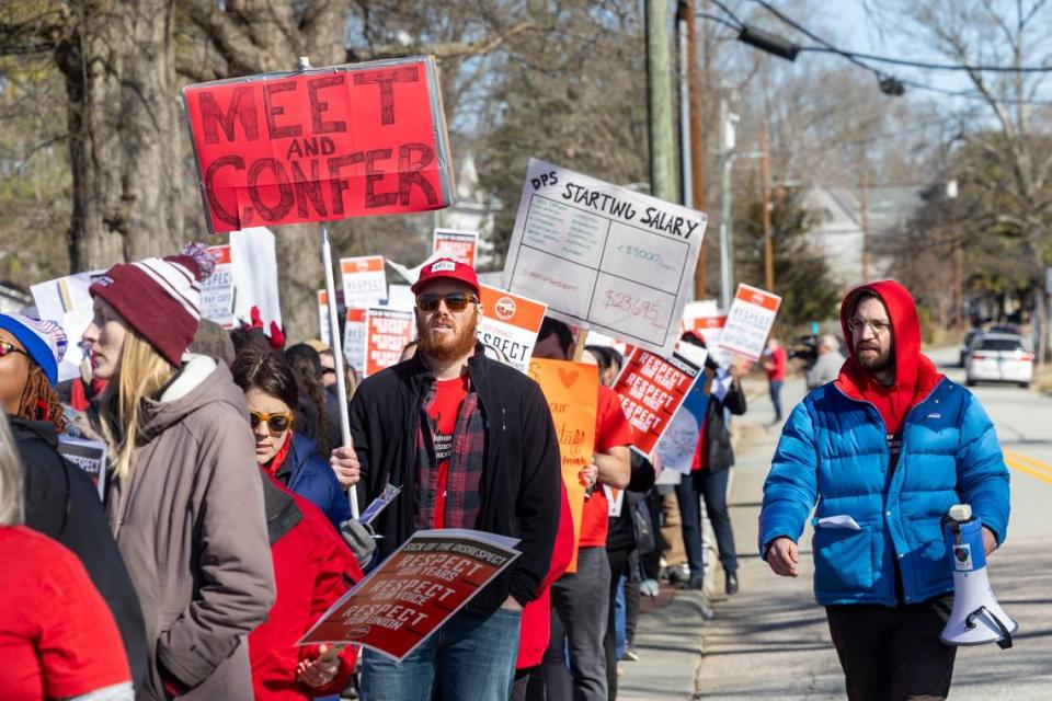 Durham County Public Schools staff, parents and community members rally and picket outside DPS’s Fuller Building in downtown Durham Monday, Feb. 5, 2024. Salary issues have plunged the district into chaos. The issues stem from an accounting error that resulted in administration withdrawing raises promised to 1,300 school staff, prompting protests and strikes since mid-January.