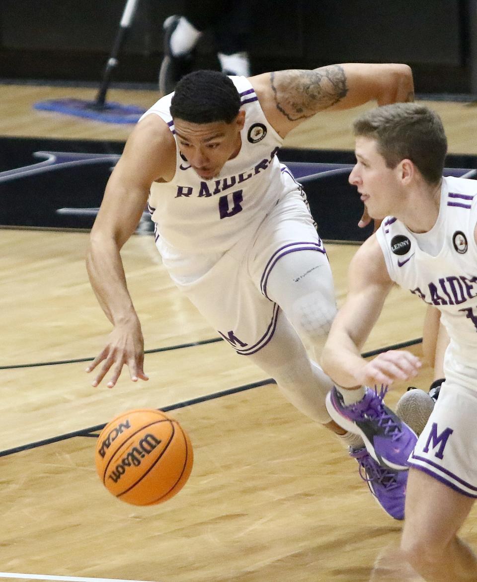 Mount Union's Jeffrey Mansfield (0) takes the ball upcourt against Whitworth during the season opener Friday, November 11, 2022.