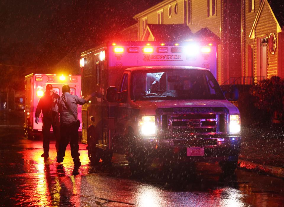 Brewster Ambulance paramedics transport a person suffering from life-threatening gunshot injuries from 93 Tribou St. to a hospital on Tuesday, March 14, 2023.